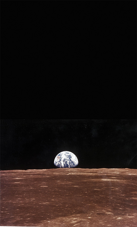 The Earth appears on the horizon as Armstrong and Aldrin prepare to walk on the moon 